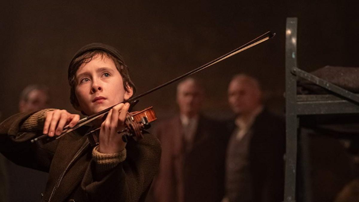 Young Dovidl (Luke Doyle) plays the violin in François Girard's 'The Song of Names'.