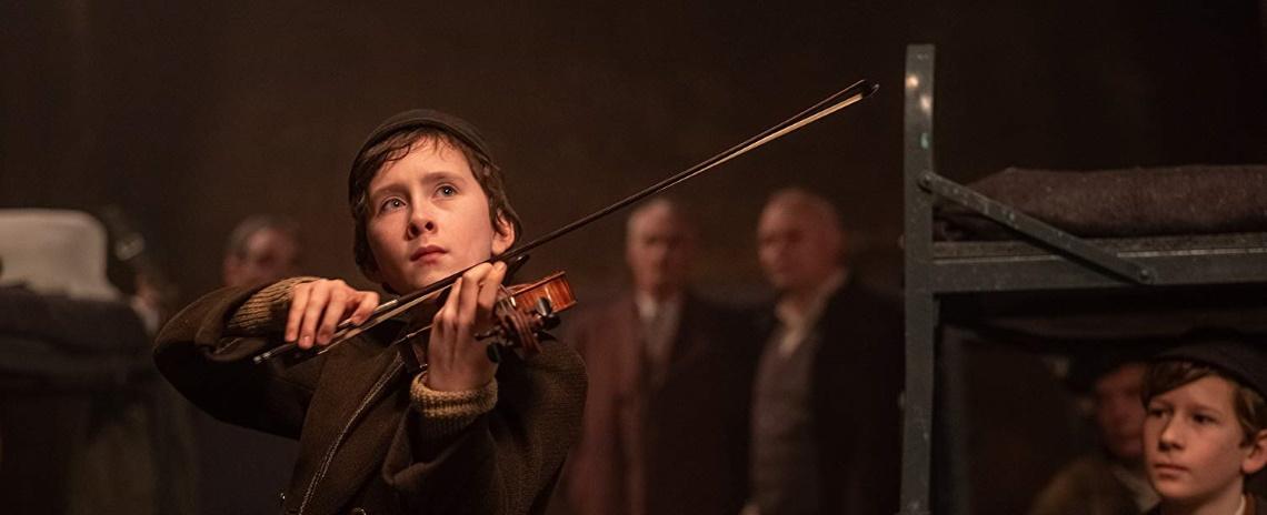 Young Dovidl (Luke Doyle) plays the violin in François Girard's 'The Song of Names'.